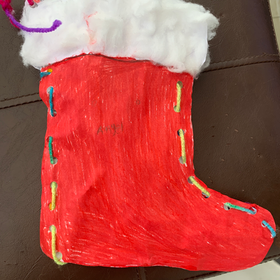 Angel Stitched a Christmas sock.png