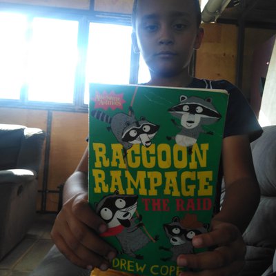 Gabriel reading 'Raccoon Rampage.'.jpeg